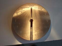 brass sundial at noon
